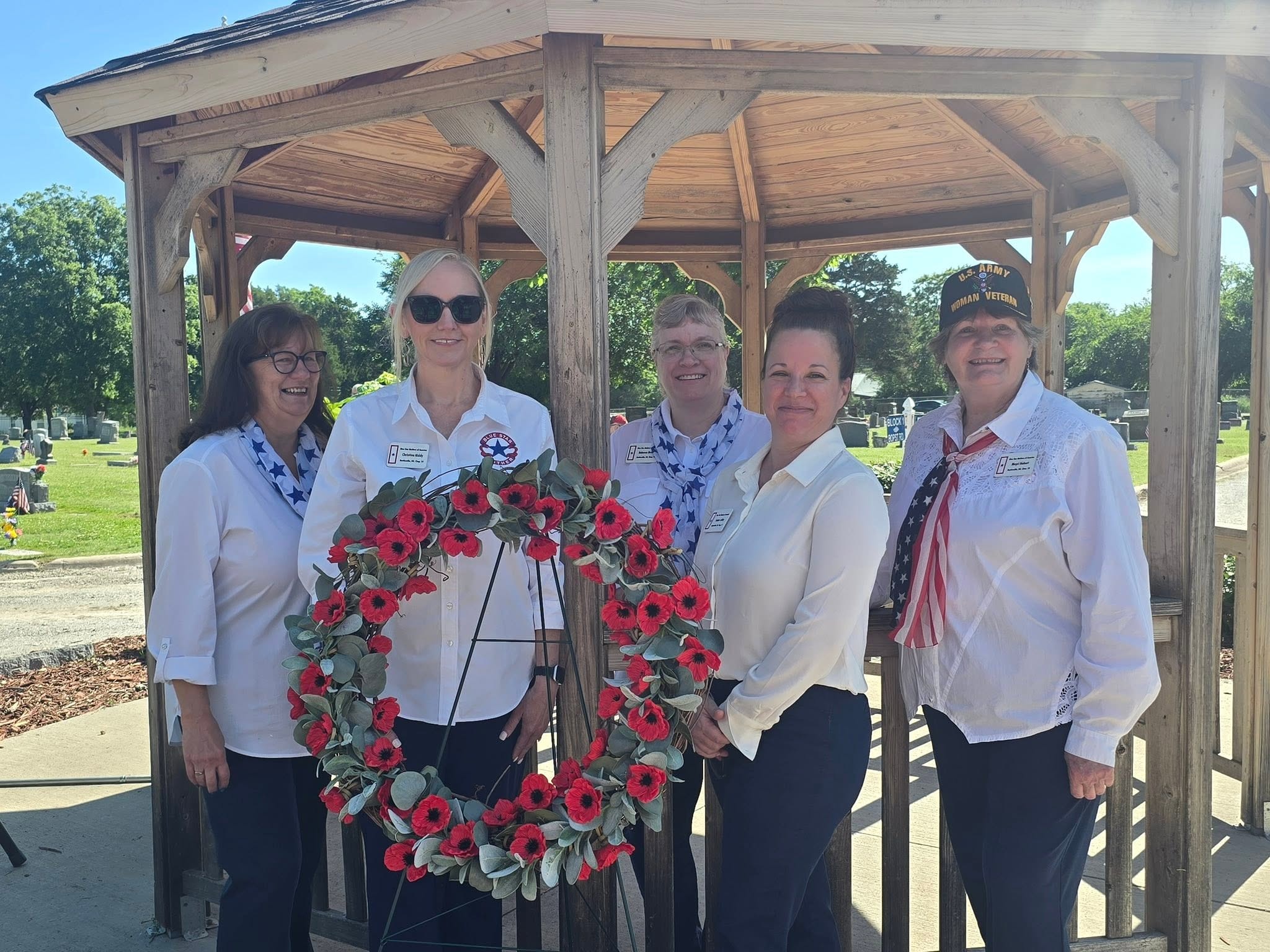 Blue Star Mothers chapter officers at Veterans Day ceremony with poppy wreath